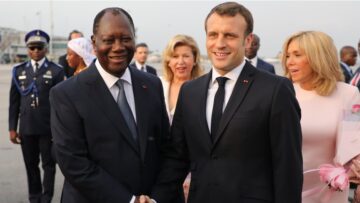 France’s President Emmanuel Macron (2ndR) is greeted by Ivory Coast’s